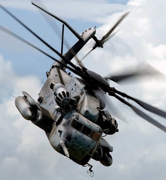Military helicopter flying through the sky showcasing aviation power and versatility.